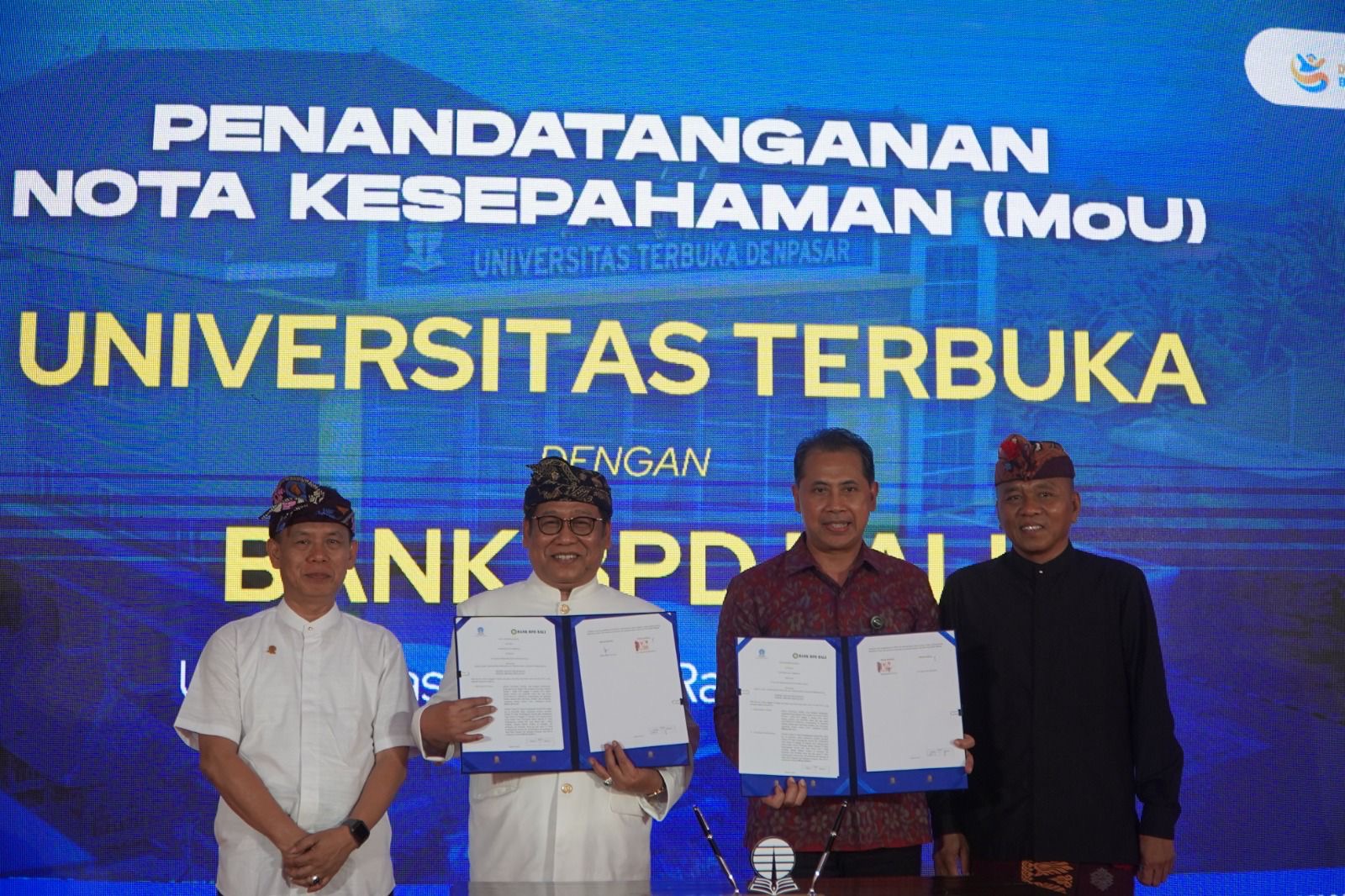 Foto: Direktur Bisnis Bank BPD Bali, I Nyoman Sumanaya (kedua dari kanan) dan pimpinan Universitas Terbuka Denpasar menunjukkan dokumen nota kesepahaman usai penandatanganan kerja sama antara Bank BPD Bali dengan UT Denpasar, Rabu (2/7/2025). Sumber: dok